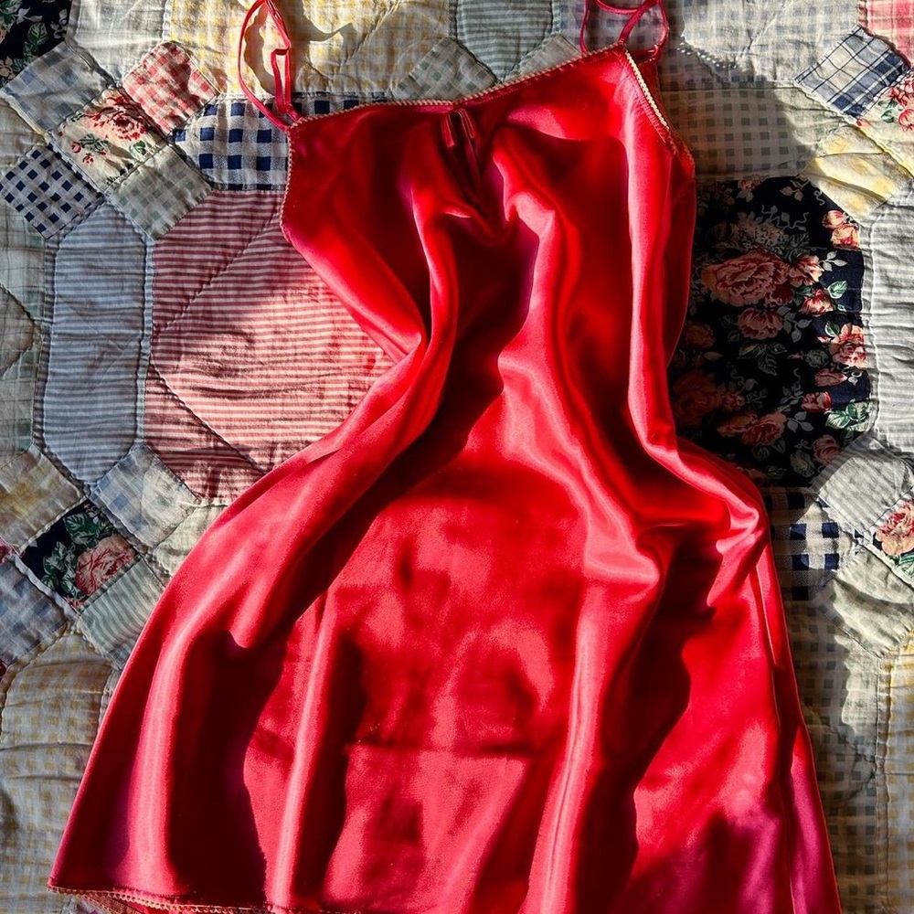 Pink satin slip dress with lace trim and little bow